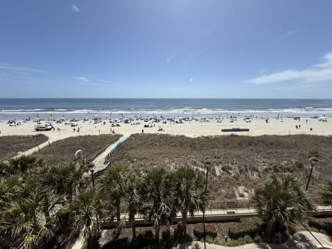 Oceanfront balcony with panoramic beach and sunset views