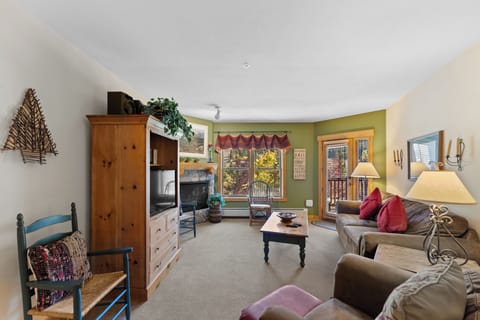 Settle into your cozy living space where warm wood accents and comfortable seating create the perfect mountain retreat atmosphere.