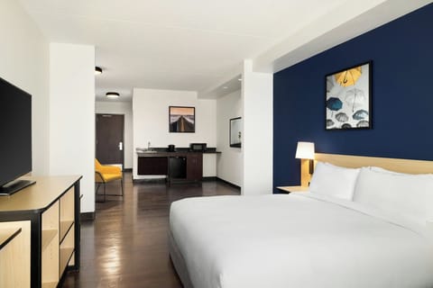 Premium bedding, desk, laptop workspace, blackout drapes
