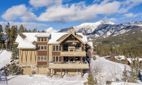 Stunning mountain lodge nestled in snowy peaks offers breathtaking alpine views and cozy winter retreat vibes.