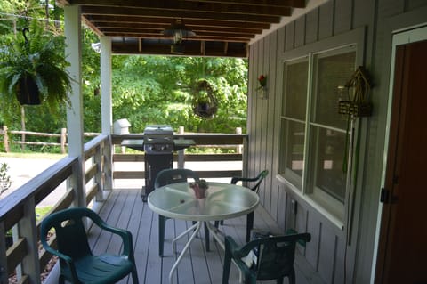 Large deck with dining table with seating for 2, gas grill, dog gate