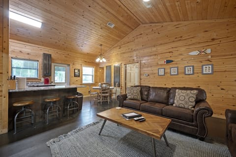The living room opens to the dining area and kitchen with bar seating.