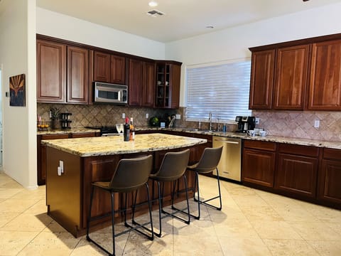 Large kitchen that comes fully stocked. Walk-in pantry providing plenty of space