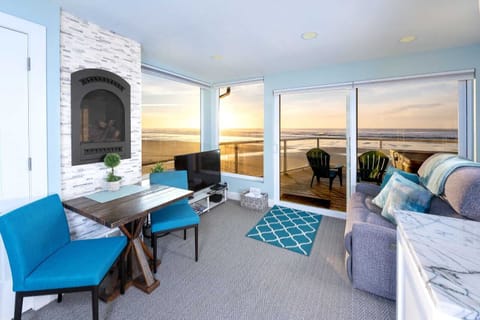 Sunlit living room w/ ocean views, comfy seating & easy access to the deck