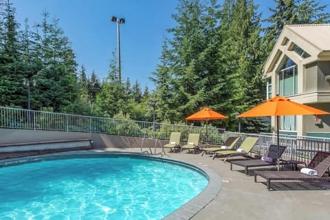 - Sparkling outdoor pool surrounded by loungers and forest views  
- Perfect spot for sunny relaxation after skiing or exploring  
- Year-round heated comfort for mountain-inspired downtime  