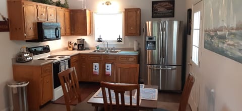 kitchen stocked with dishes, pots and pans, coffeemaker, and utensils 