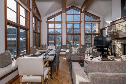 Stunning mountain views frame your spacious open-plan living area, where floor-to-ceiling windows flood the room with natural light.