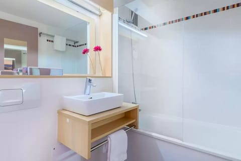 Bathtub, eco-friendly toiletries, hair dryer, towels