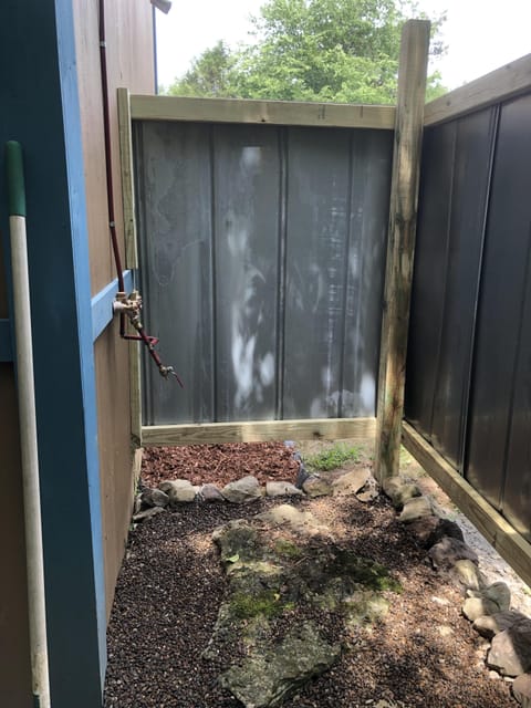 Outdoor shower with Hot Water & robe/towel hooks overlooking the creek