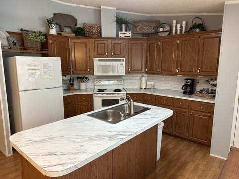 Open and bright kitchen well-equipped with everything needed to prepare meals. 