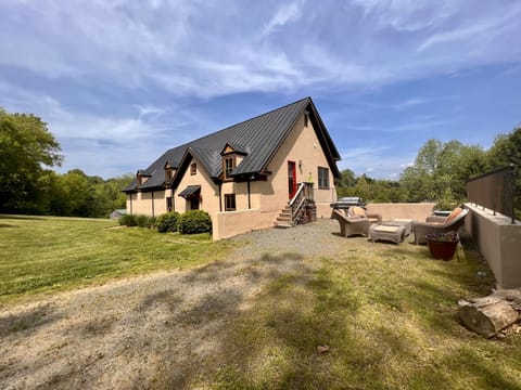 The Cottage showing side entry and seating area. Large BBQ for your convenience