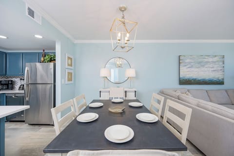 Dine comfortably at the table, surrounded by calming blue walls and a relaxed atmosphere perfect for gatherings