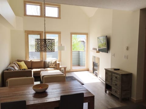 Living area, gas fire place, flat screen TV & door to private balcony.