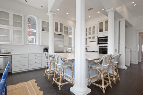 The kitchen features countertop seating and high-end appliances