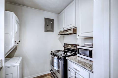 The stackable laundry is off of the kitchen. Perfect for a corporate stay.