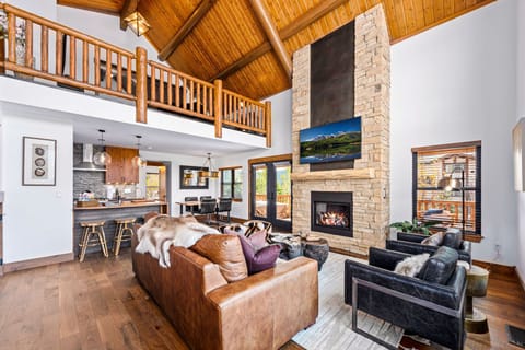 Living room, kitchen and fireplace view