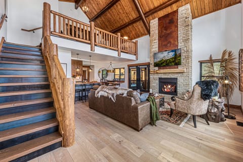 Living area with 25 foot tall fireplace and 50 inch smart TV