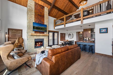 Living area with 25 foot tall fireplace and 50 inch smart TV