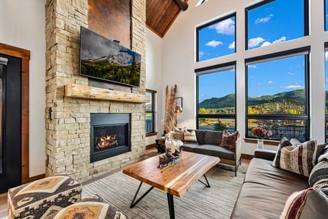 Living area with 25 foot tall fireplace and 50 inch smart TV