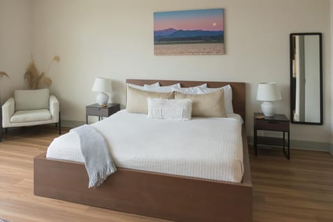 Spacious bedroom with serene views and cozy seating area