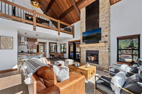 Living area with 25 foot tall fireplace and 50 inch smart TV