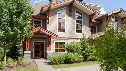 - Beautiful townhouse surrounded by evergreens and trails  
- Modern mountain architecture with inviting entry design  
- Ideal Whistler base for families and outdoor explorers  
