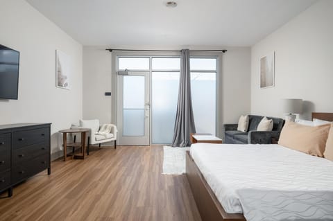 Bright and airy bedroom with cozy seating and balcony access