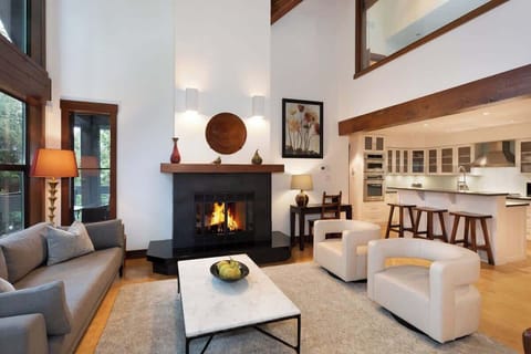 - Bright living room with tall windows and glowing fireplace warmth  
- Modern mountain décor blending wood beams and soft neutral tones  
- Perfect space to unwind after a day on the slopes  
