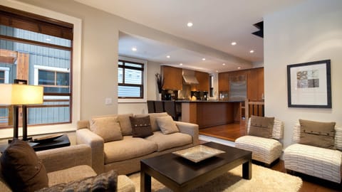 - Warm living room with plush sofas and a modern open layout  
- Large windows welcome natural light and peaceful forest views  
- A perfect space to unwind after a day on the slopes  