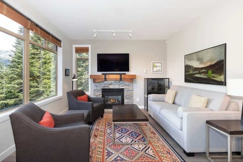 - Elegant mountain-view living with fireplace comfort  
- Large windows showcase Whistler’s alpine beauty  
- Relax in style after skiing or hiking adventures  