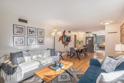 - Open layout connects the bright living area with a sleek dining nook and modern kitchen
- Light hardwood floors and bold artwork give the space a polished yet warm feel
- Ideal for entertaining or spending time together as a group