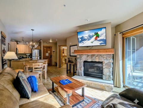 Cozy up in your spacious alpine retreat with stone fireplace, modern kitchen, and mountain views—perfect for après-ski relaxation.