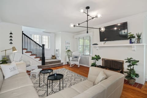 Living room with plush area rug, 55" Smart TV and leather sectional
