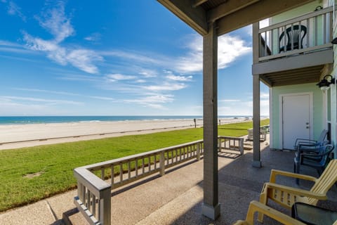 Wake up to pristine sandy shores and endless ocean views right from your private covered patio with comfortable seating.