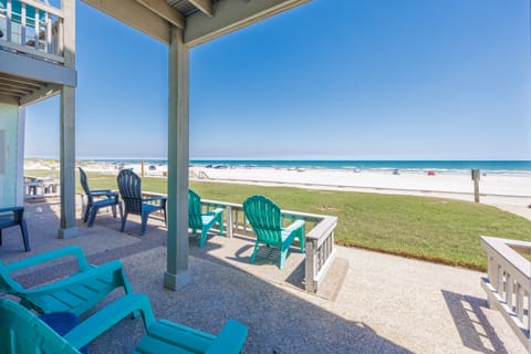 Step onto your beachfront patio and sink into colorful chairs while ocean waves dance just steps from your door.