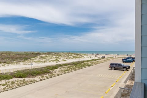 Beachfront property offers direct access to pristine sandy shores with convenient parking and stunning coastal views.