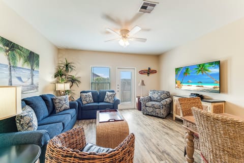Sink into coastal comfort in your tropical-themed living room, complete with plush seating and beach-inspired decor for ultimate relaxation.