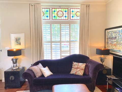 The living room with one of 2 sofas
