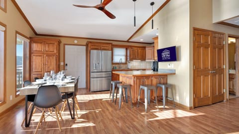 Open kitchen, dining and living room area with enough dinnerware for 12 people.