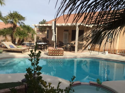 Relax in private back yard with pool and spa. 