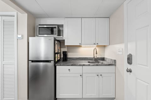 Kitchenette, stocked with microwave, refrigerator, crockpot, electric skillet, toaster oven, and blender.