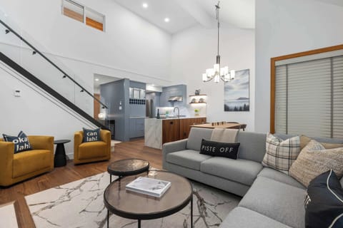 - Spacious living area with modern rustic charm and tall ceilings  
- Cozy fireplace and warm lighting create a welcoming retreat  
- Perfect for relaxing after a day of skiing or exploring  

