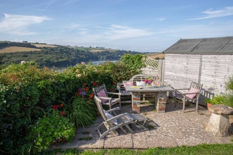Sunny outdoor patio seating area at bottom of garden with lovely views