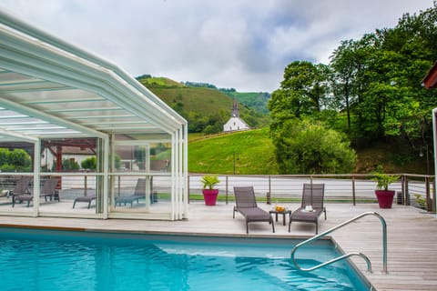 Seasonal outdoor pool, open 10:00 AM to 7:00 PM, pool umbrellas