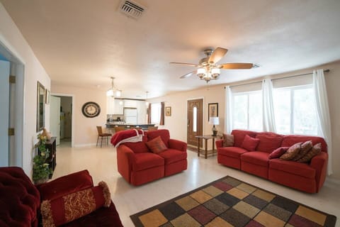 Relax in a cozy living area filled with warm natural light and plush, comfy sofas—perfect for unwinding and feeling right at home.