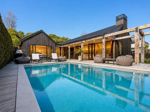 Pool area with glass sliding doors opening up to the open plan living, dining and kitchen area