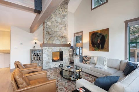 - Inviting living room with stone fireplace and warm mountain charm  
- Plush leather chairs and soft couches for fireside relaxation  
- Vaulted ceilings and rustic beams create cozy alpine ambiance  
