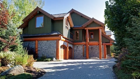 - Stunning timber-frame mountain home with stone details  
- Spacious driveway and landscaped path welcome your arrival  
- Perfect blend of rustic charm and modern alpine design 