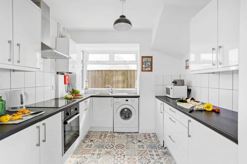 The kitchen with a washing machine - Lighthouse View