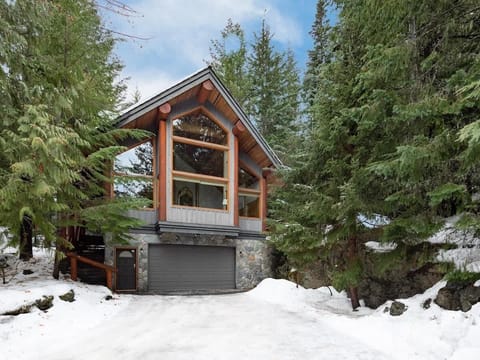 - Snowy forest retreat surrounded by evergreens for a peaceful mountain getaway  
- Warm wood beams and tall windows showcase rustic alpine charm and natural light  
- Perfect cabin escape near ski slopes and forest trails for winter adventure  